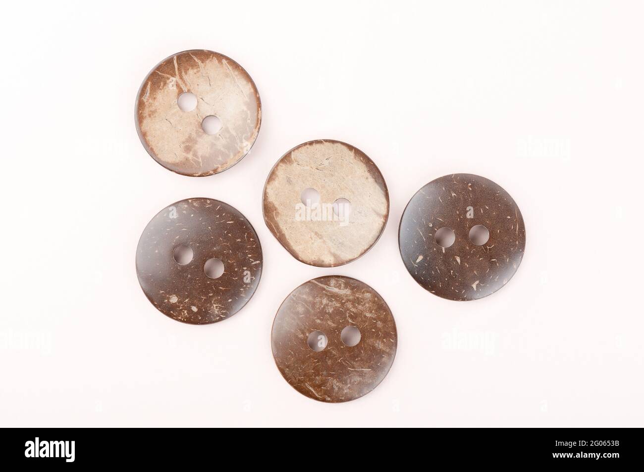 Several brown marbled plastic buttons on both sides. Top view. Stock Photo
