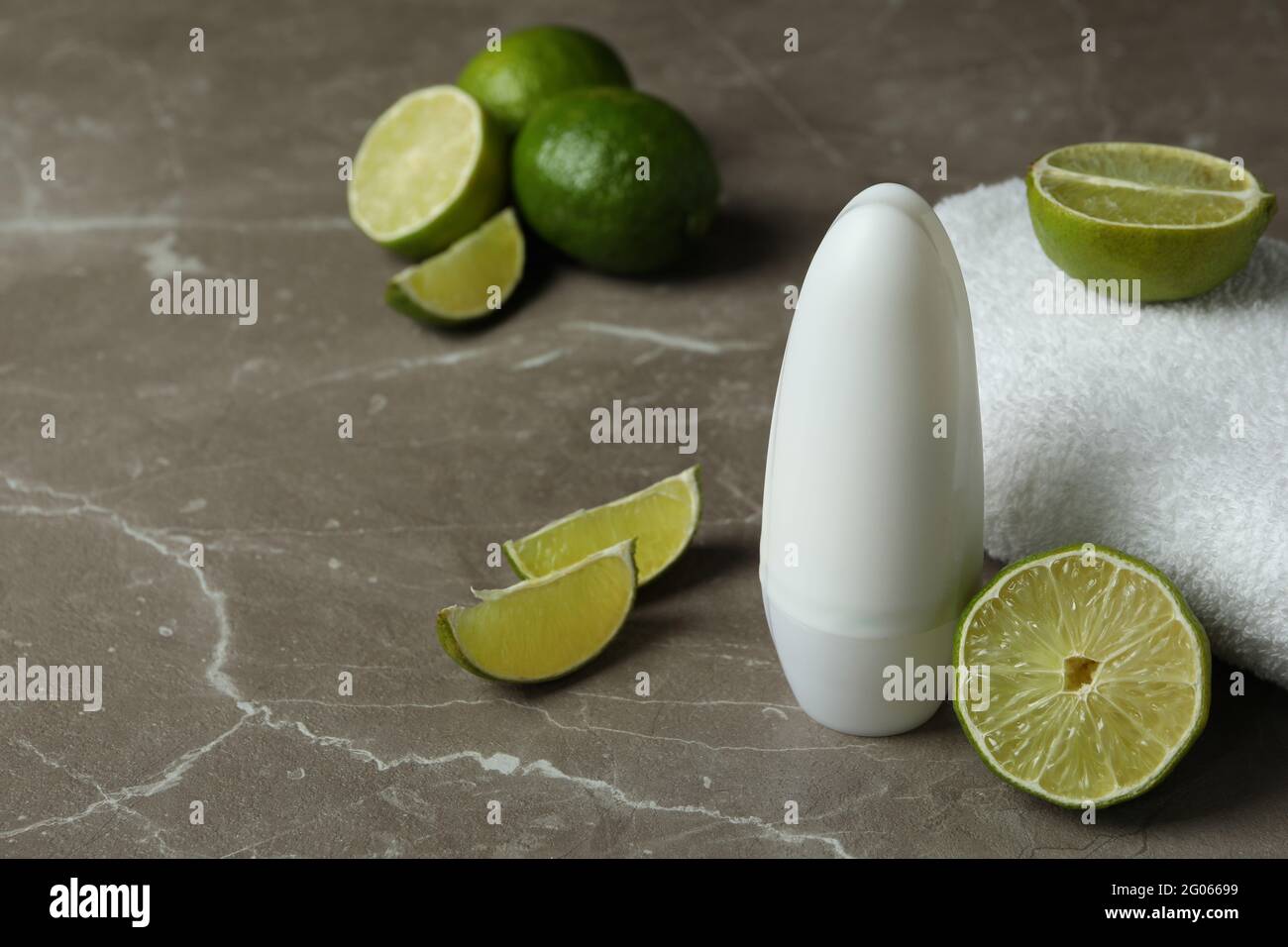 Blank deodorant, limes and towel on gray table Stock Photo Alamy
