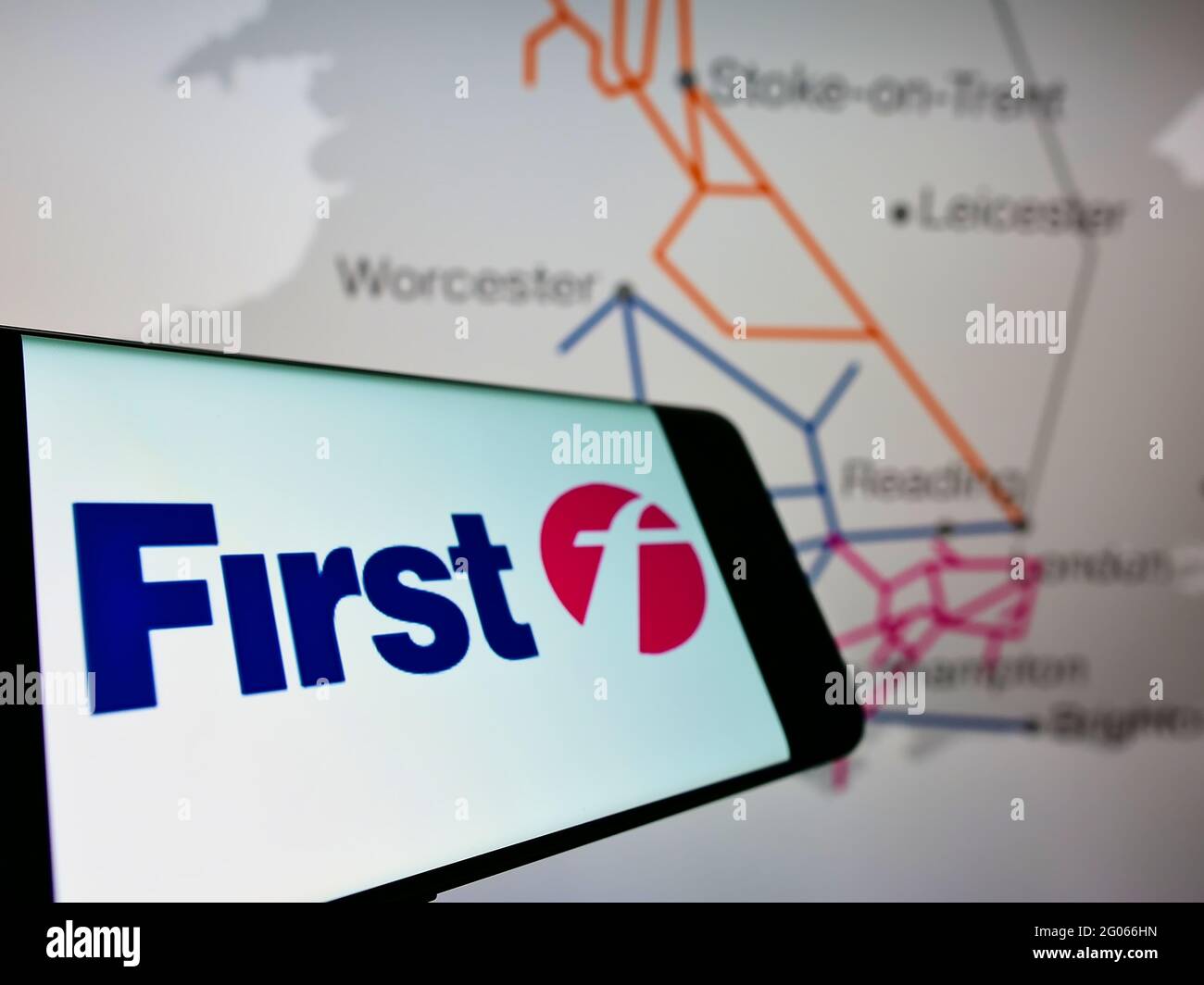 Smartphone with logo of British transport company FirstGroup plc on screen in front of business website. Focus on center-right of phone display. Stock Photo