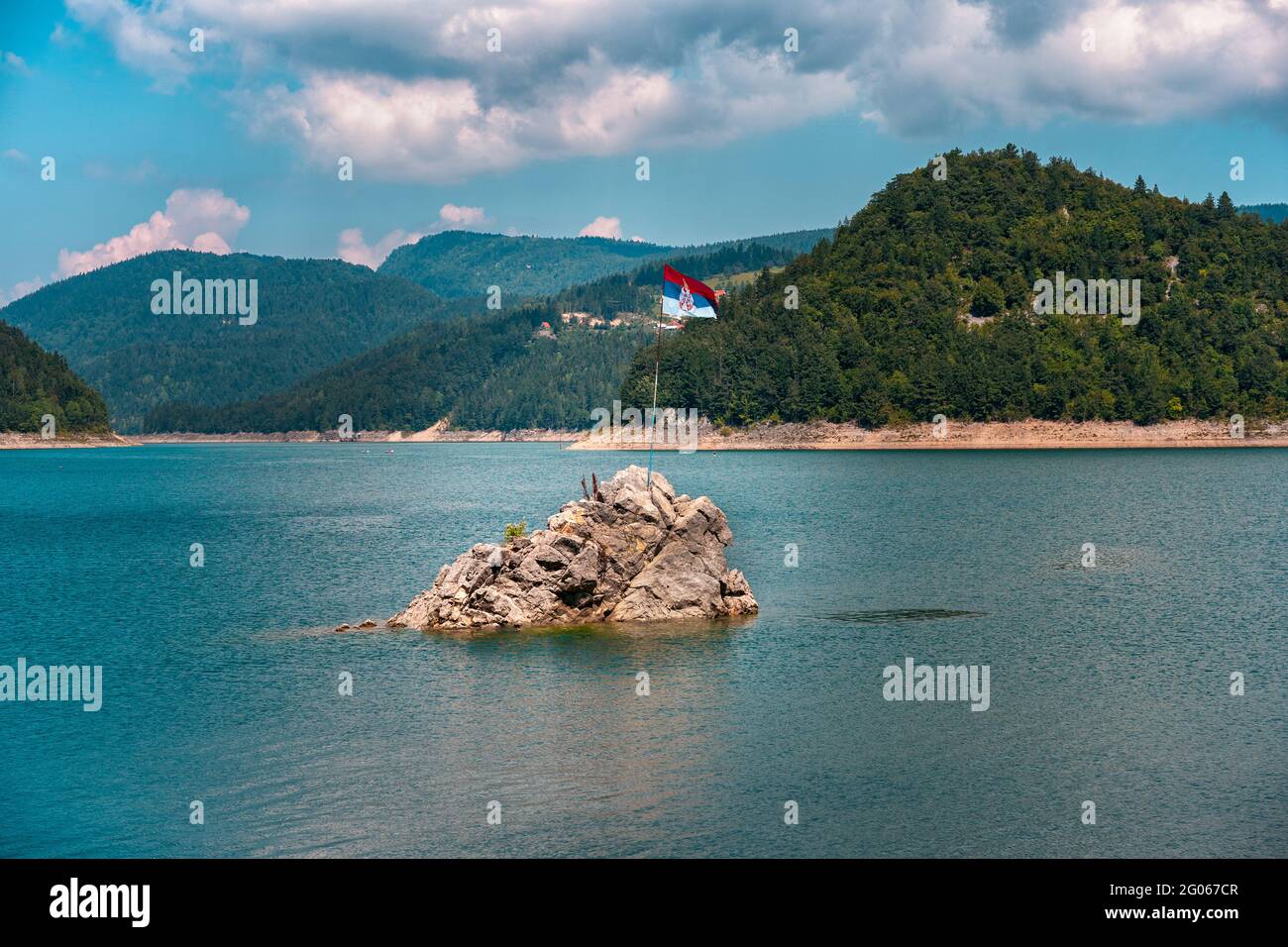 Serbian flag waving on a pole at a lonley island in the middle of Zaovine lake, Tara mountain Stock Photo