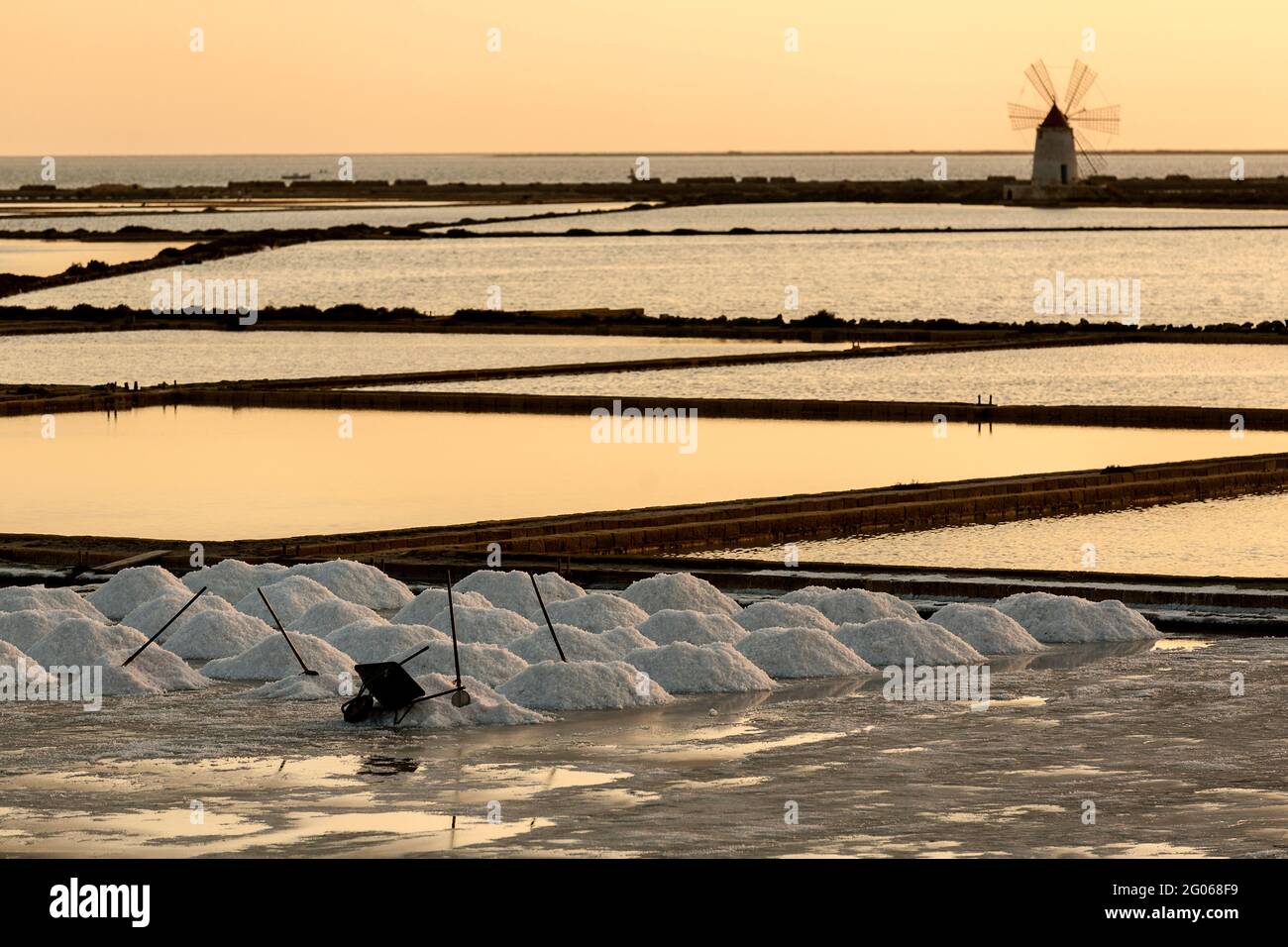 Saltworks at sunset,  Saline of Trapani, windmill, nature reserve, Stagnone of Marsala, Sicily, Italy, Europe Stock Photo