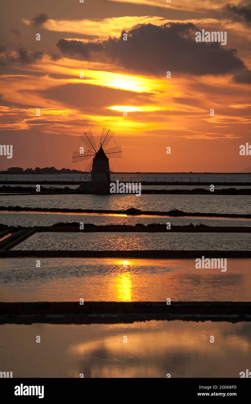 Saltworks at sunset,  Saline of Trapani, windmill, nature reserve, Stagnone of Marsala, Sicily, Italy, Europe Stock Photo