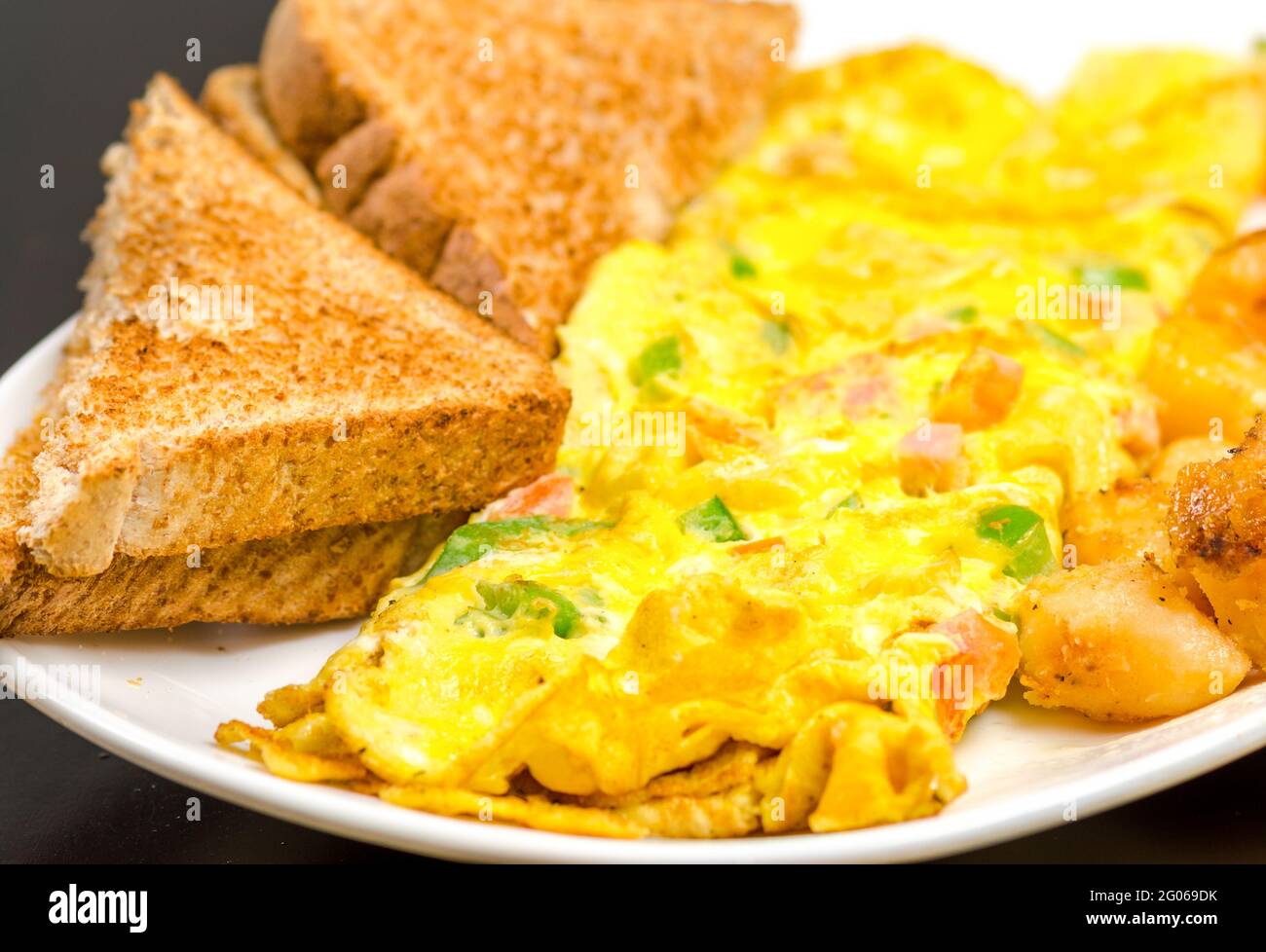 Omelette and toasts. Food with a dark background Stock Photo