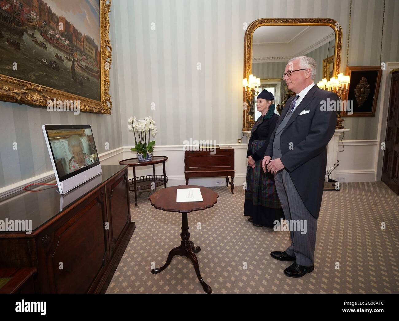 Queen Elizabeth II appears on a screen via videolink from Windsor Castle, where she is in residence, during a virtual audience to receive His Excellency Sturla Sigurjonsson, Ambassador of Iceland, and his wife Elin Jonsdottir, who attended Buckingham Palace, London. Picture date: Tuesday June 1, 2021. Stock Photo