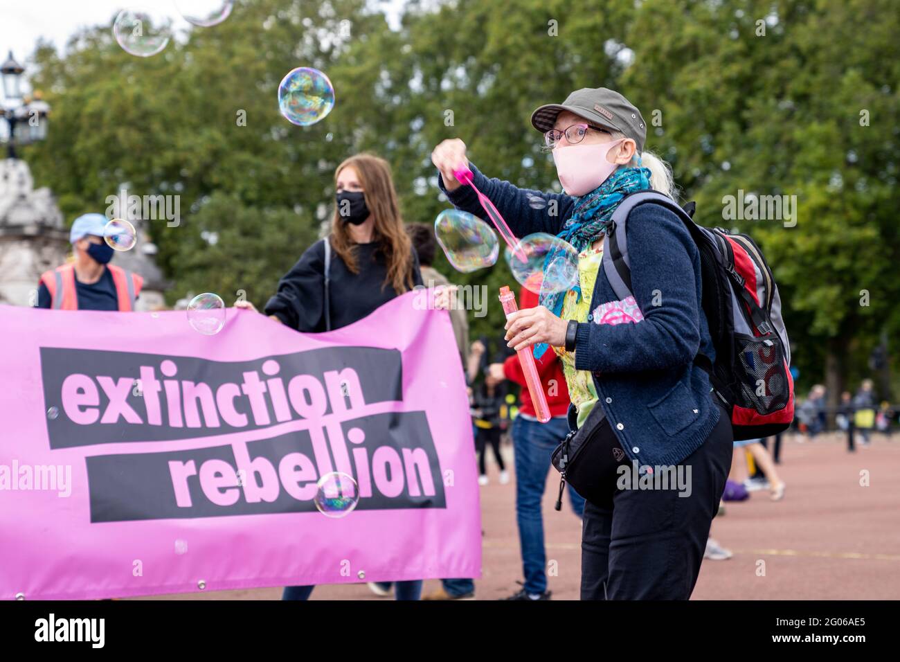 LONDON, UK - Extinction Rebellion demonstrators hold banners and blow bubbles during a climate change protest by Buckingham Palace Stock Photo