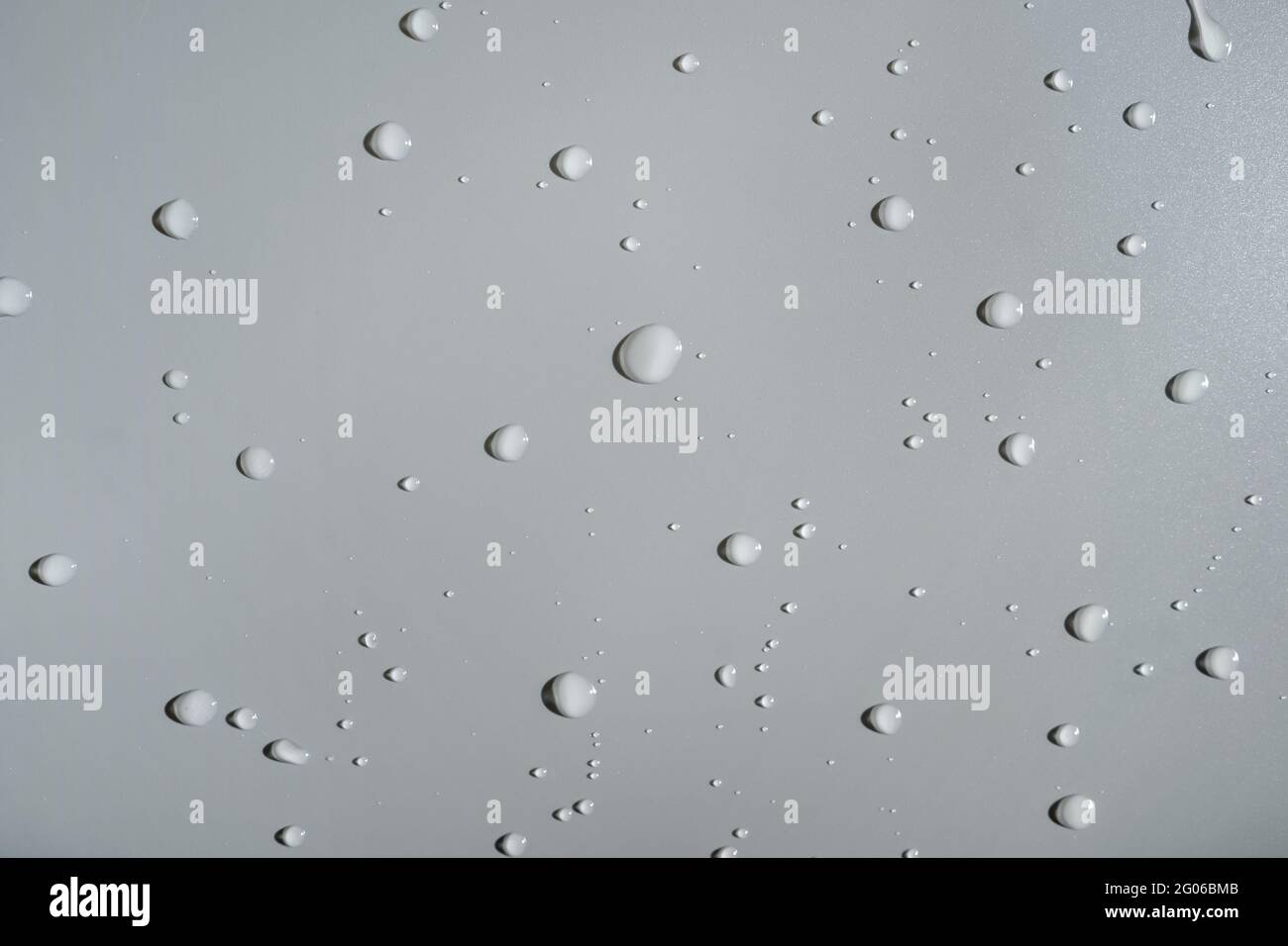 Water drops on gray background, top view. Copy space. Stock Photo