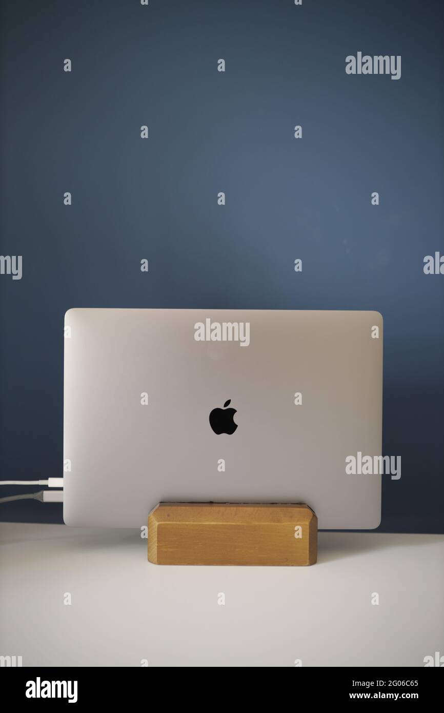 BRCKO DISTRIC, BOSNIA AND HERZEGOVINA - May 01, 2021: Space grey Apple  MacBook Pro 16 inch on wooden vertical laptop stand, connected to power and  ext Stock Photo - Alamy