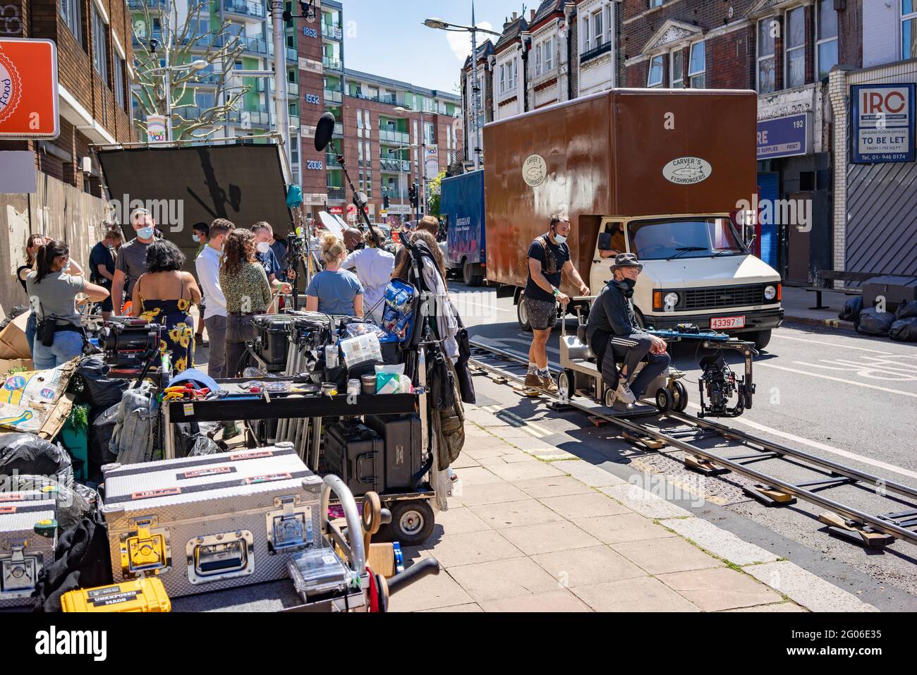 Film crew in Peckham Rye street in south London filming with Director