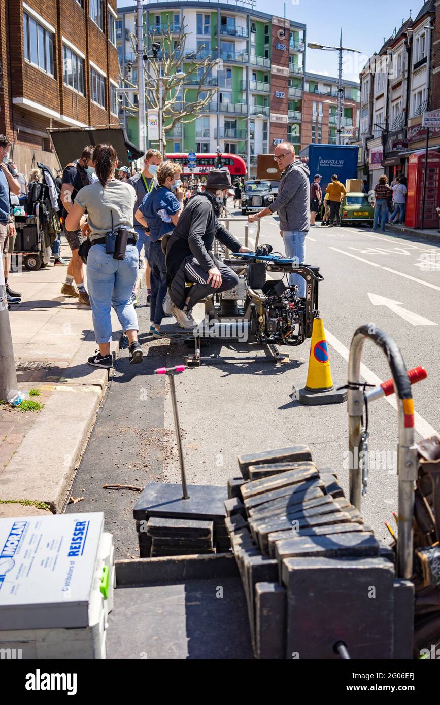 Film crew in Peckham Rye street in south London filming with Director Danny Boyle 2021 Stock Photo