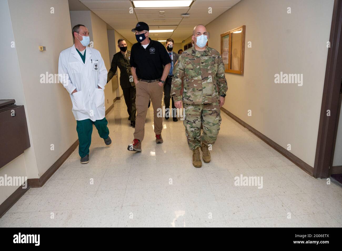 Reportage:  Acting Defense Secretary Chris Miller walks with the director of medicine at Walter Reed National Military Medical Center, Army Col. Jeremy Edwards, and Walter Reed Director Army Col. Andrew Barr, after receiving a vaccination for COVID-19, Walter Reed National Military Medical Center, Bethesda, Md., Dec. 14, 2020. Stock Photo