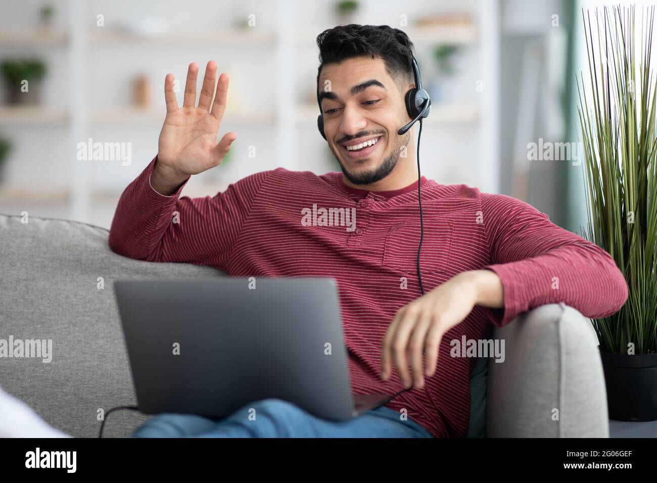 Positive arab guy working from home, having video conference Stock Photo