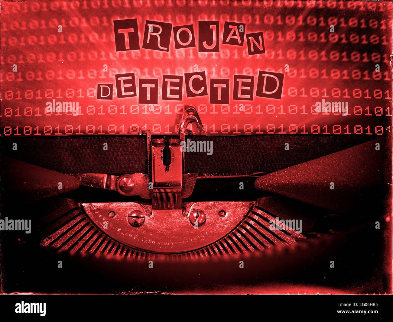 Trojan Detected, Mechanical Typewriter, Binary code background, Red tone, Vintage distorted look, Ransom note typography Stock Photo