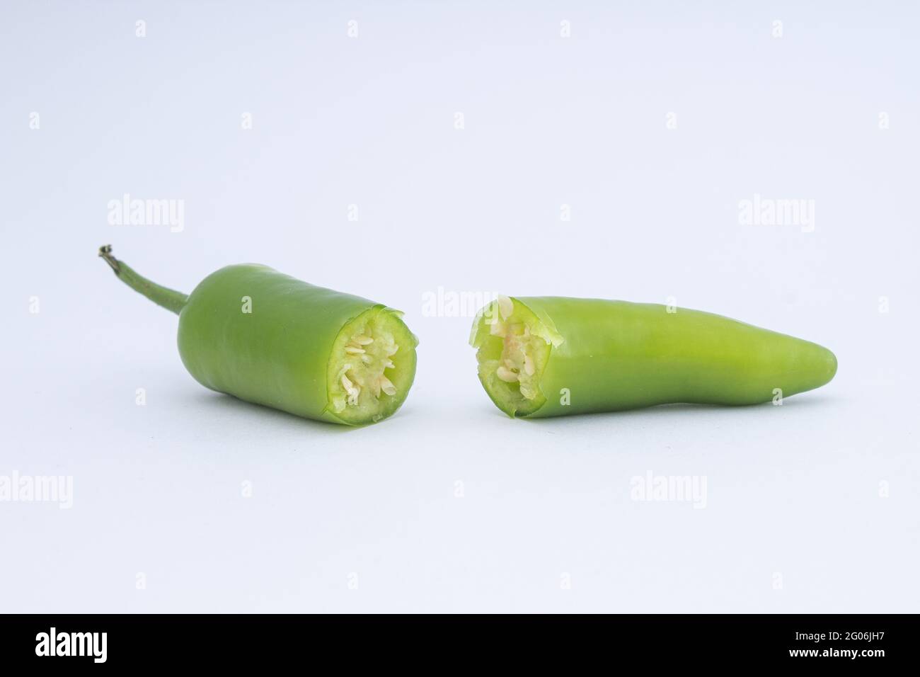 Green hot peppers on a white background Stock Photo - Alamy