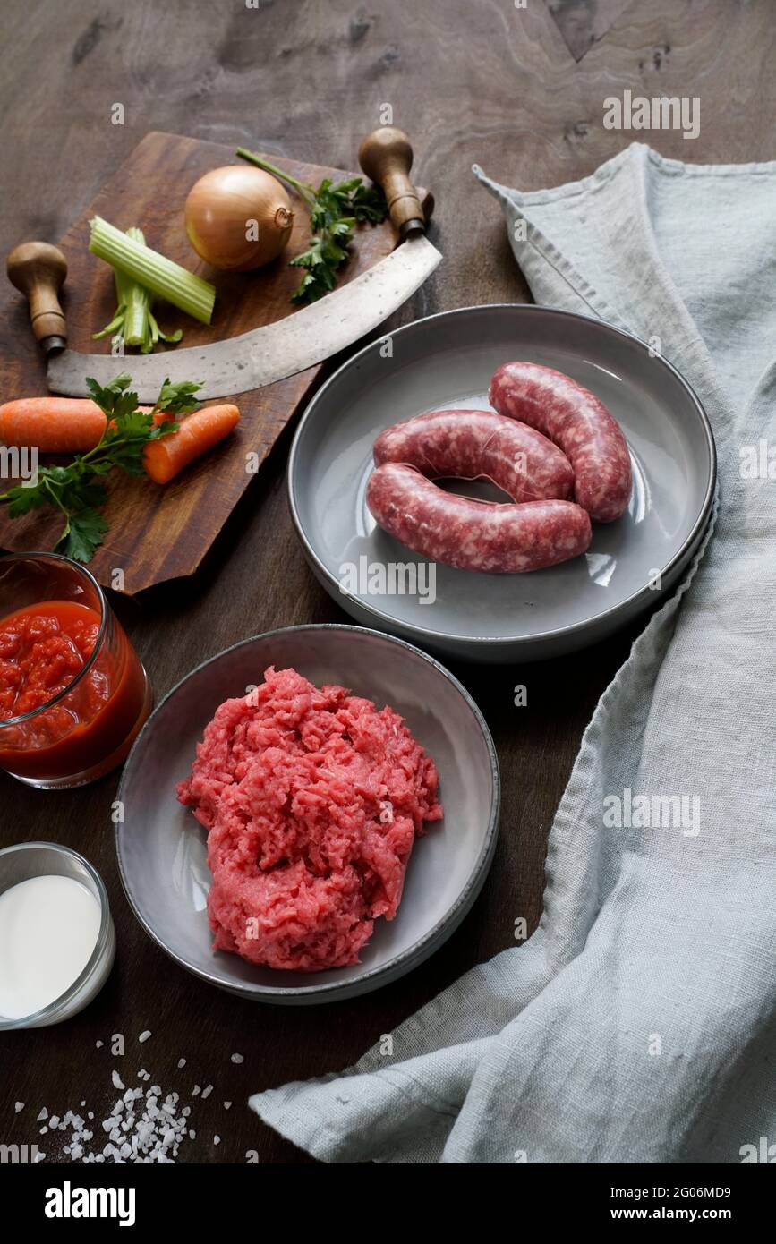 Ingredients for the preparation of meat bolognese ragout, ground beef, pork, thick tomato sauce