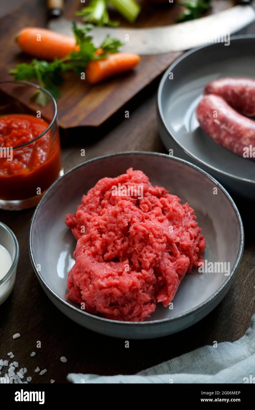 Ingredients for the preparation of meat bolognese ragout, ground beef, pork, thick tomato sauce