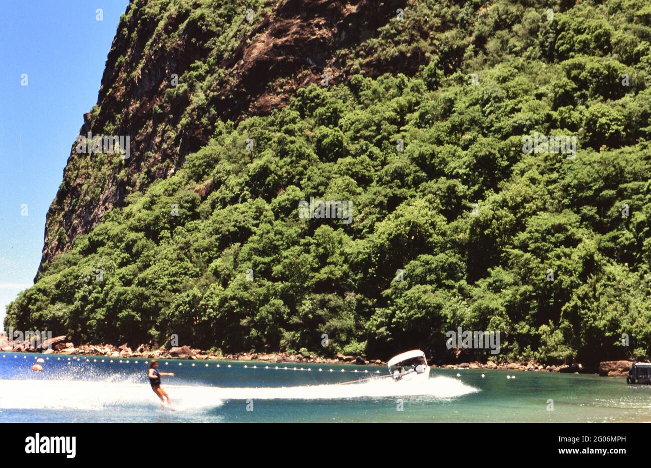 1990s St. Lucia (Eastern Caribbean) - Tourist waterskiing at base of Petit Piton ca. 1995-1999 Stock Photo