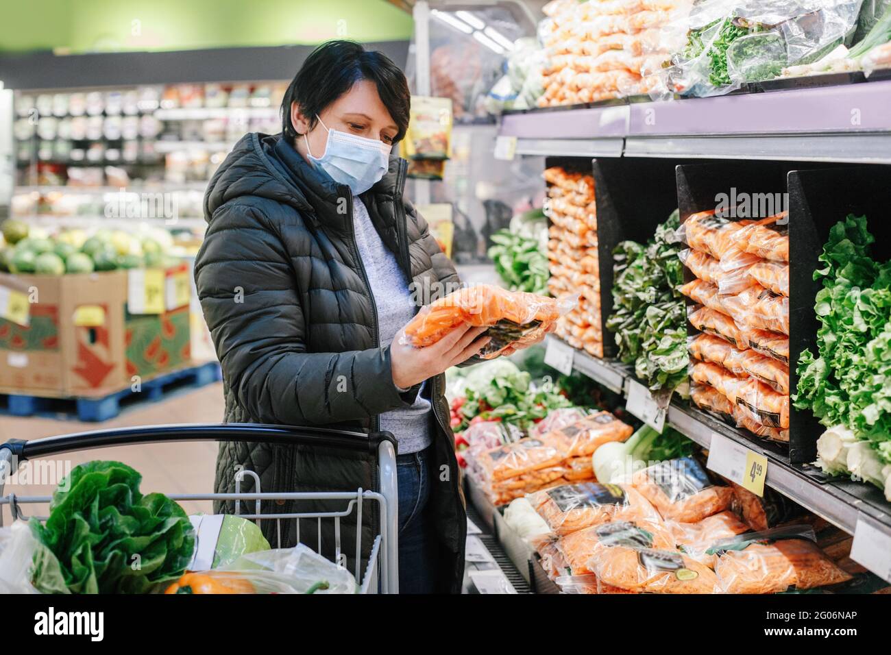 Grocery Shopping Middle Age Woman With Short Dark Hair In Blue