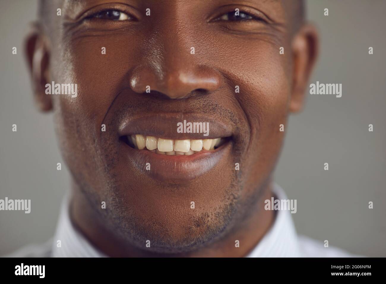 Closeup portrait of a handsome young African-American man with a happy cheerful smile Stock Photo