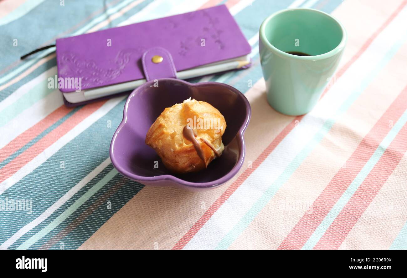 Breakfast with sweets, coffee and notebook Stock Photo