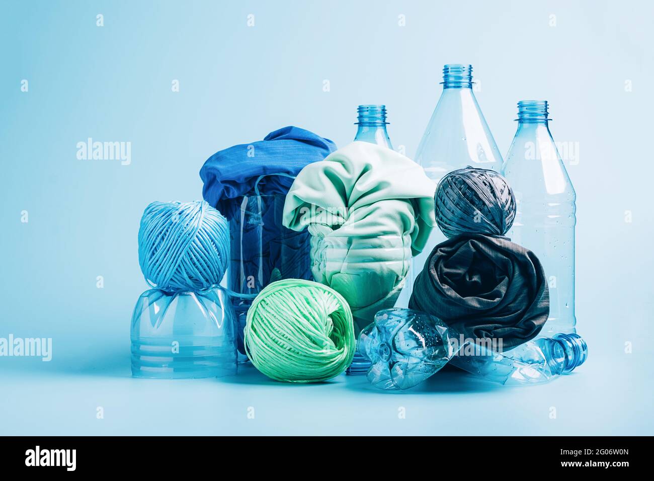 Plastic recycling and reuse concept. Empty plastic bottle and various fabrics made of recycled