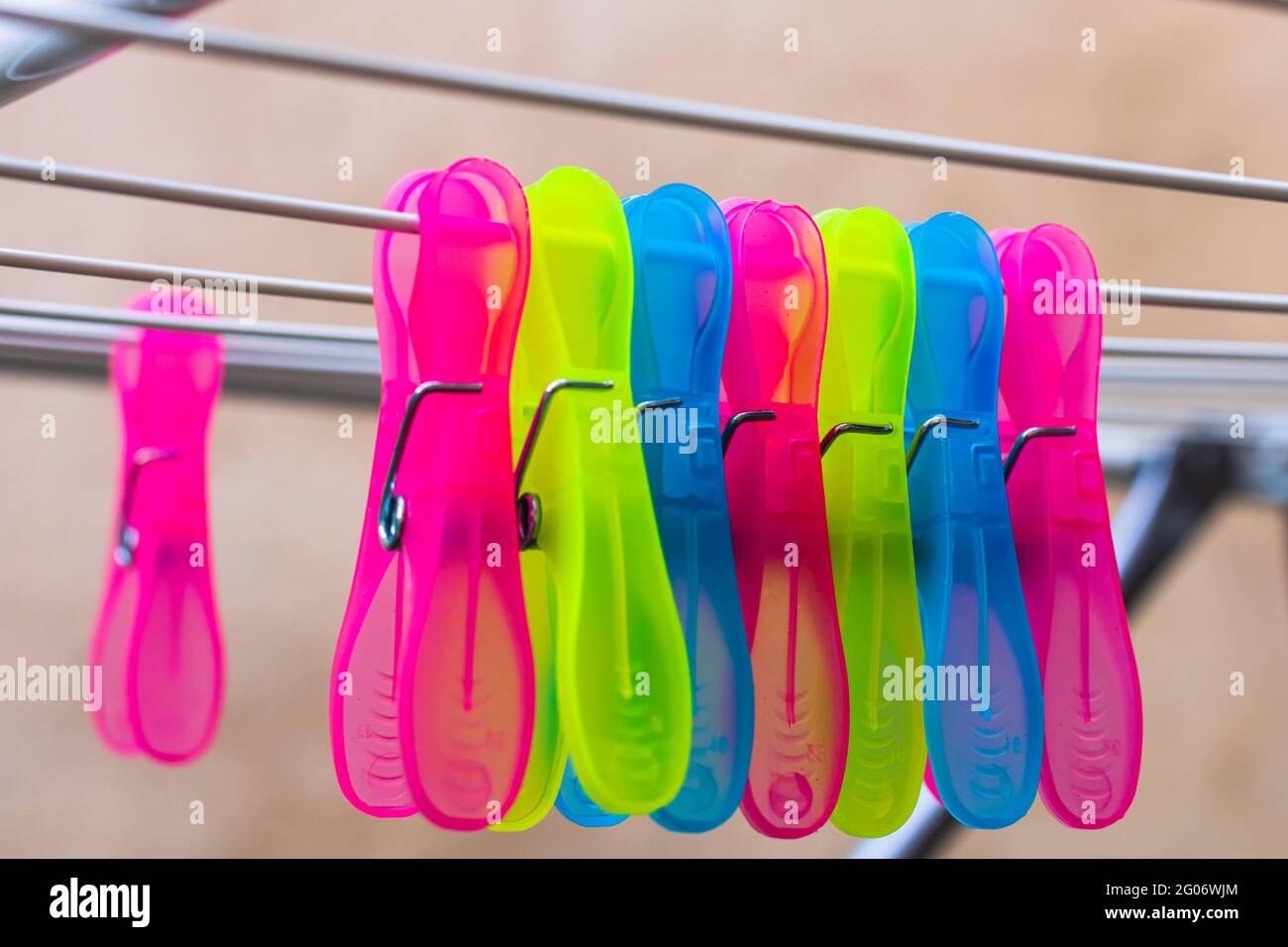 Colorful plastic clothes pegs on empty metal clothes dryer Stock Photo Alamy