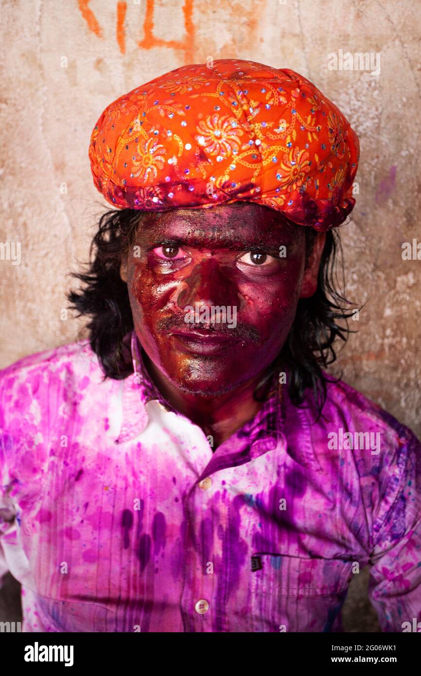Indian man portrait with face smudged with multicolour and looking at camera Stock Photo