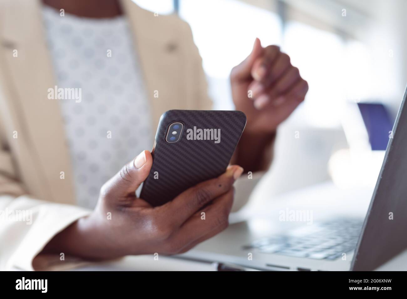 Close up of hands of african american businesswoman using smartphone Stock Photo