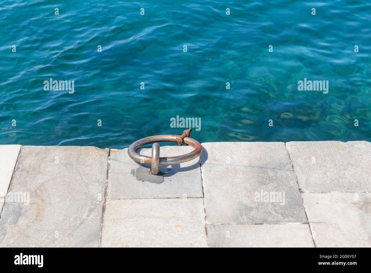 Ring Bollard. Isolated. Copy Space. High Angle View Of Ring Bollard At Harbor By Sea . Stock Image. Stock Photo