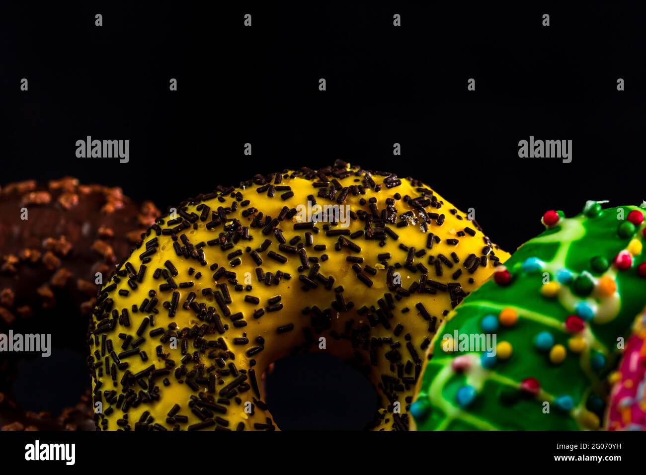 Glazed donuts with sprinkles isolated. Close up of colorful donuts ...