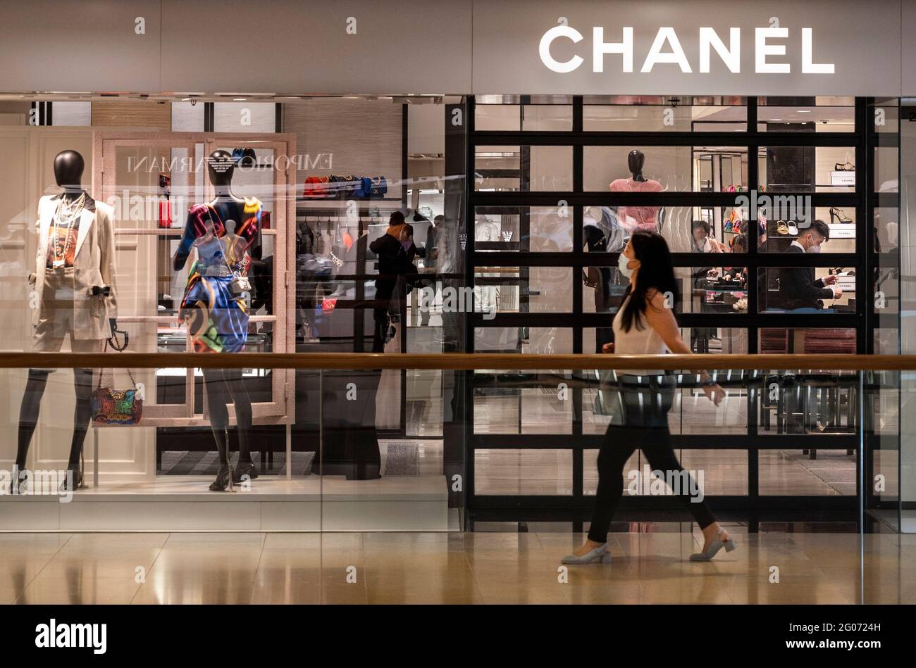 A woman walks past the French multinational clothing and beauty products  brand Chanel store seen in Hong Kong (Photo by Budrul Chukrut / SOPA  Images/Sipa USA Stock Photo - Alamy