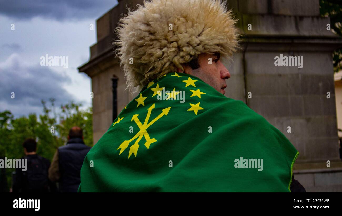 London, United Kingdom - May 23rd 2021: A Circassian wears a traditional hat and flag to raise awareness of the Circassian genocide. Stock Photo