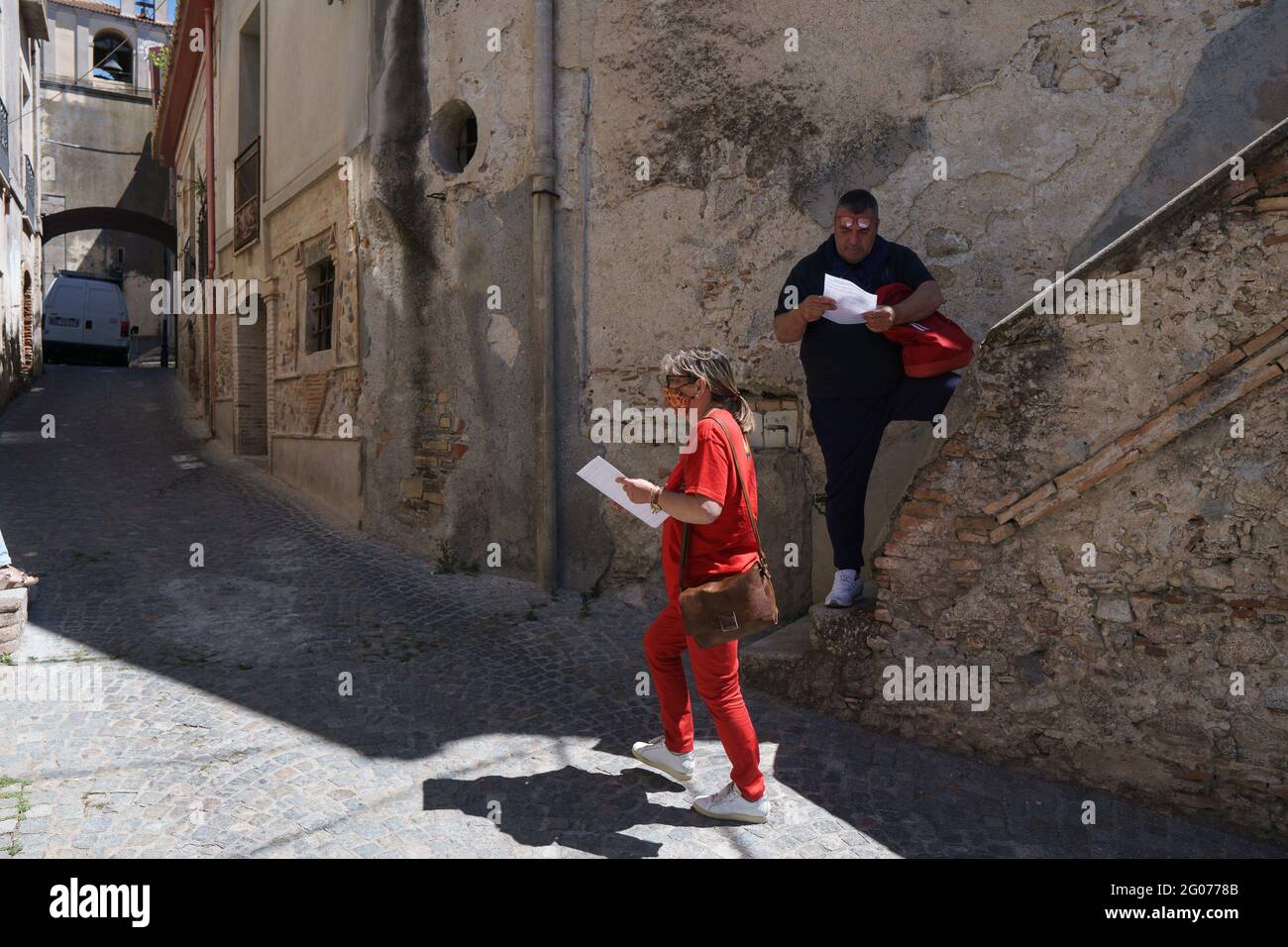 Riace, Italy. 22nd May, 2021. A woman giving out the new list pamphlets during the press conference.Domenico Lucano “Mimmo”, former pro-migrant mayor of Riace, presented the electoral list “Un'Altra Calabria è possibile” (Another Calabria is possible) for the 2021 Calabrian regional election during a press conference hosted by Journalist Pietro Melia close to the local restaurant 'Taverna Donna Rosa'. The list will support the candidature of the mayor of Napoli, Luigi de Magistris, as Calabria Region's Governor. (Photo by Valeria Ferraro/SOPA Images/Sipa USA) Credit: Sipa USA/Alamy Live News Stock Photo