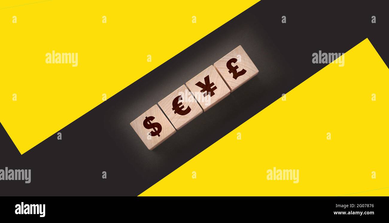 Dillar, euro, yen and pound on building blocks. wooden cubes with