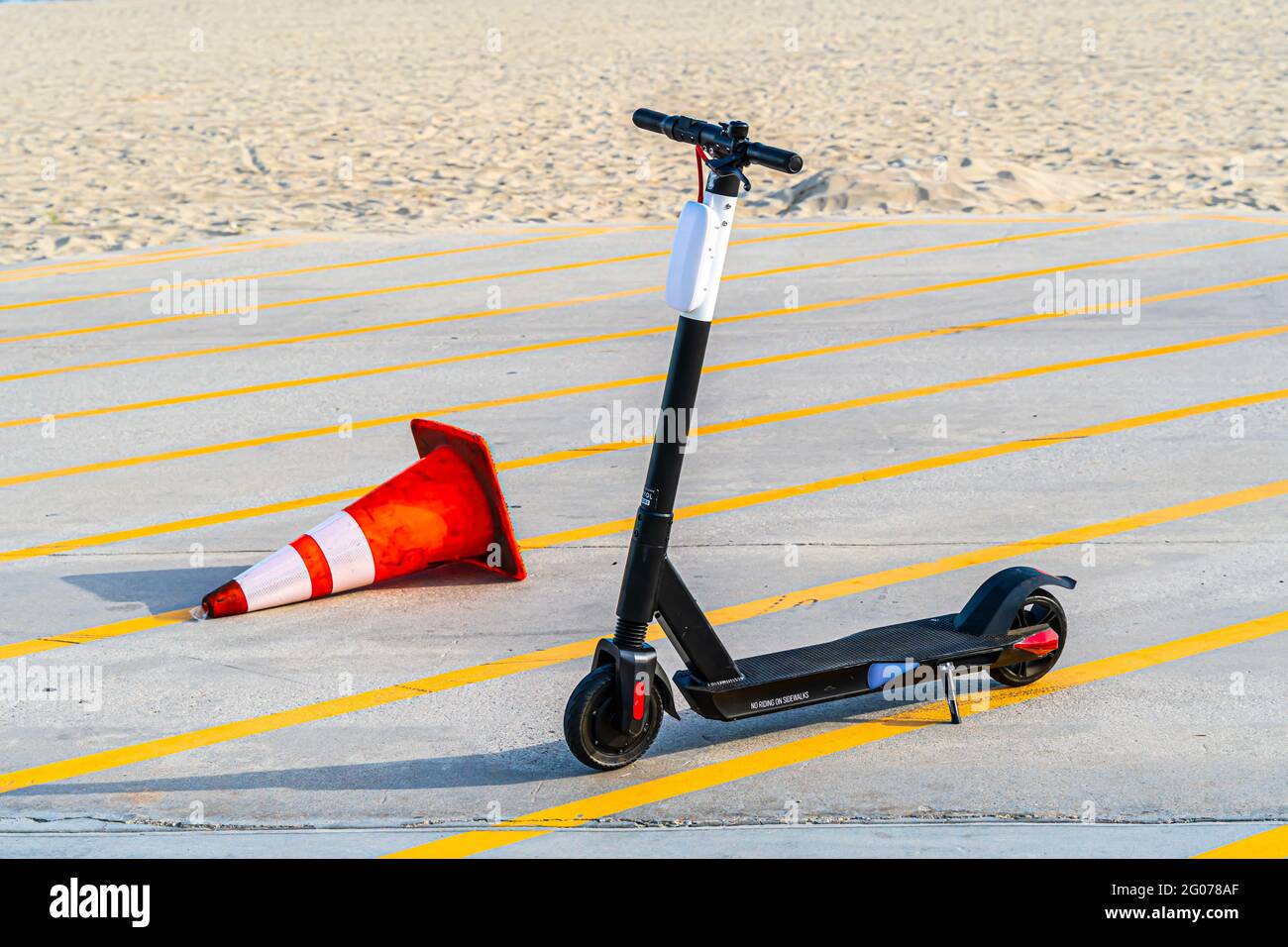 Electric Scooter and Toppled Traffic Cone Stock Photo