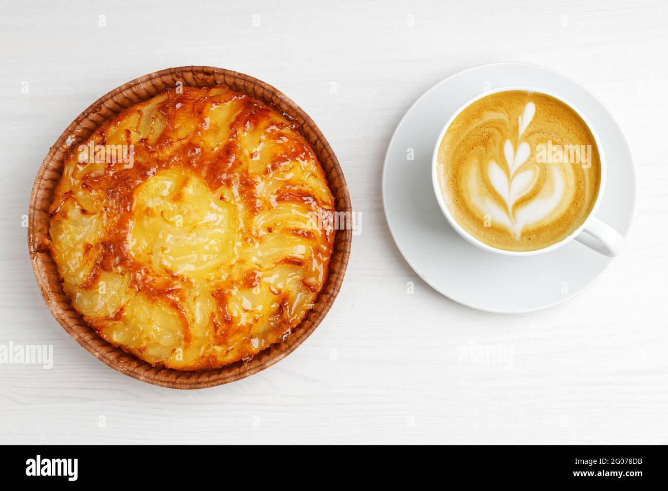 Homemade pie with apples and pears with cup of coffee cappuccino on white wooden table. Top view. Stock Photo
