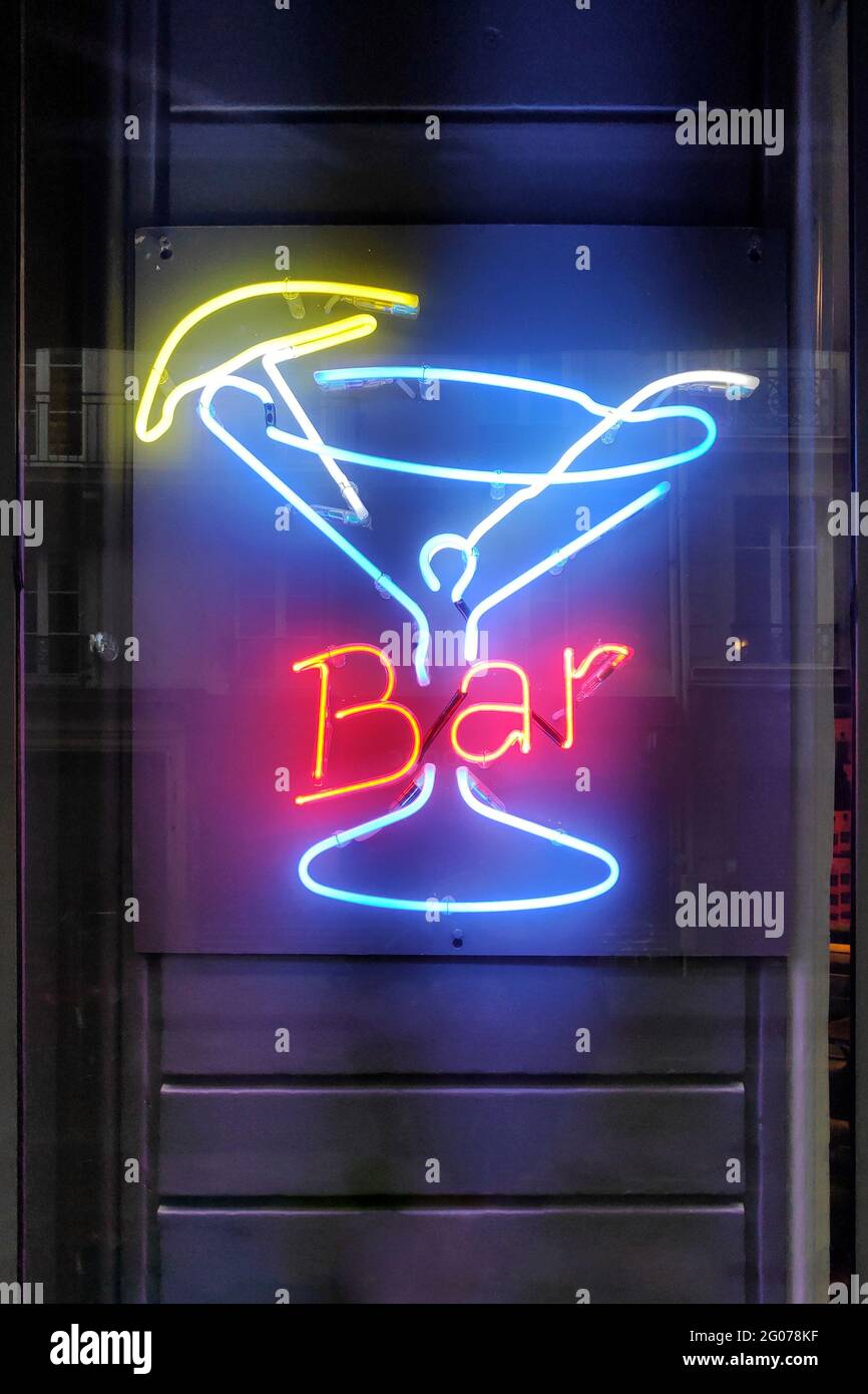Close-up on a neon light shaped into a cocktail glass with the word 'Bar'. Stock Photo