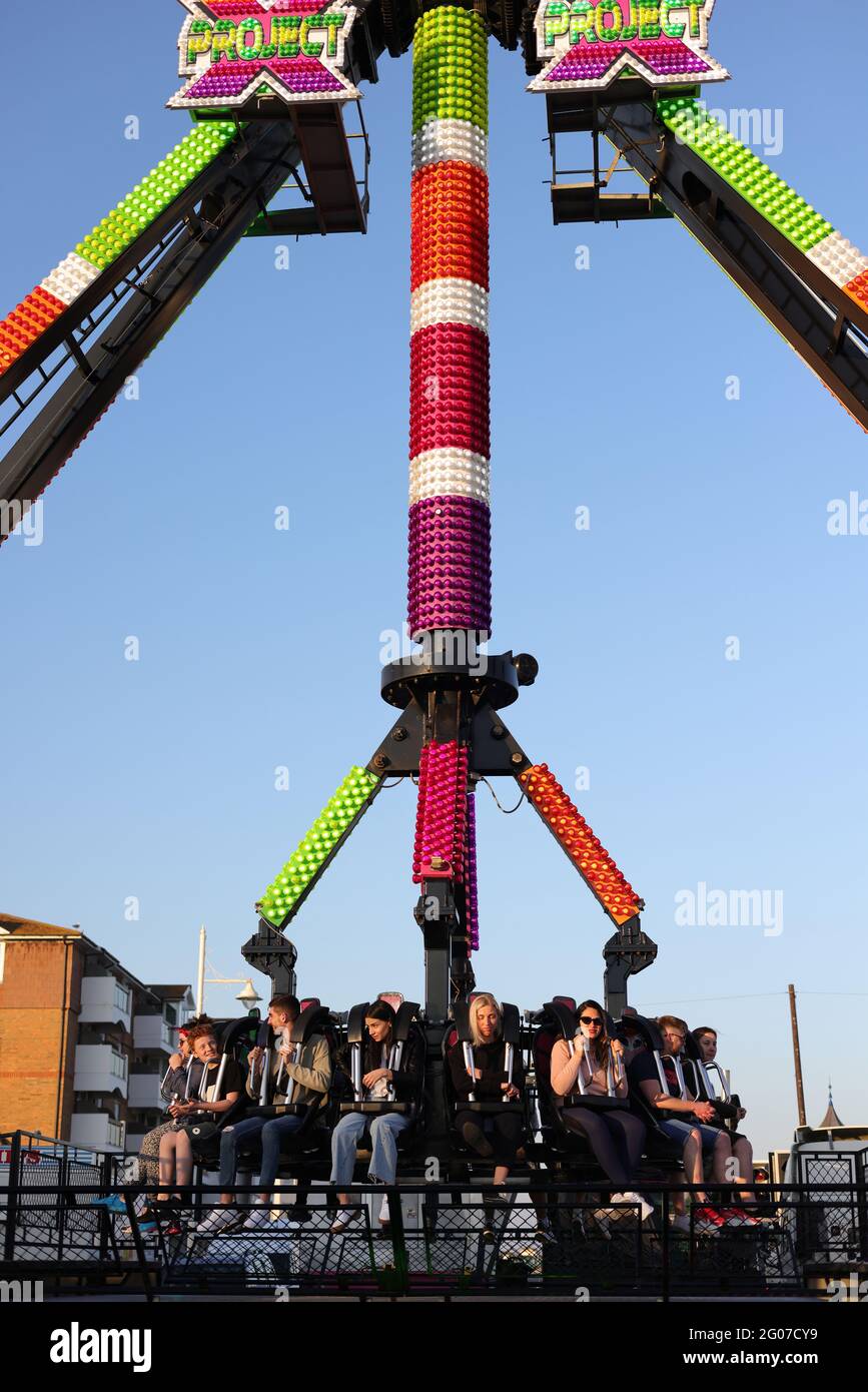 People seen on a ride at a fun fair in the UK Stock Photo - Alamy