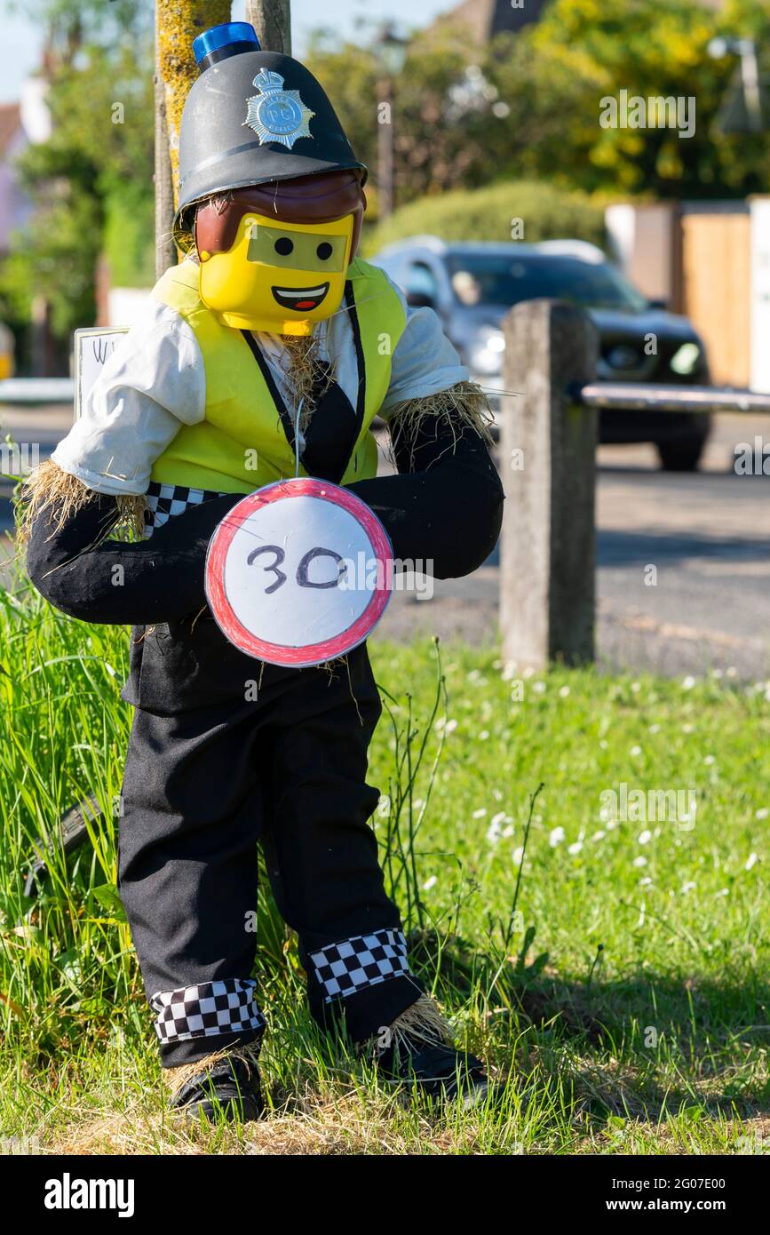 Havering-Atte-Bower, Essex, UK. 1st Jun, 2021. Havering-atte-Bower Conservation Society’s (HABCOS) second annual scarecrow competition for village residents has commenced, with judging results due soon. Entrants are confined to residents living between the village signs, which is near Romford. Scarecrows include a lego police officer with a speed limit sign Stock Photo