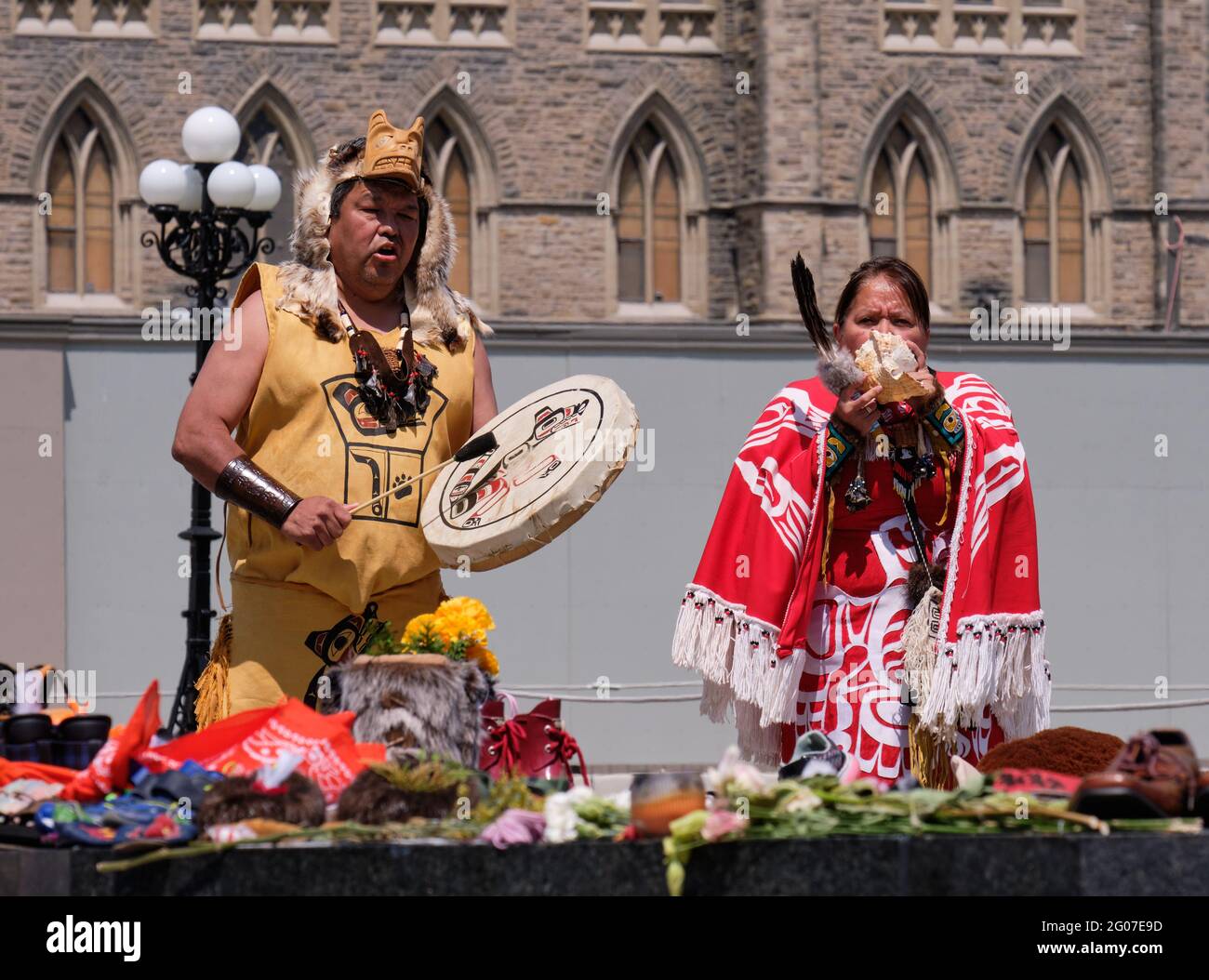 Ottawa, Canada. June 1st, 2021. A native couple perform a drum ceremony as Members of First Nations communities honour the memory of the 215 children found buried at a former Kamloops, British Colombia residential school at a memorial in front of the Canadian Parliament. Credit: meanderingemu/Alamy Live News Stock Photo