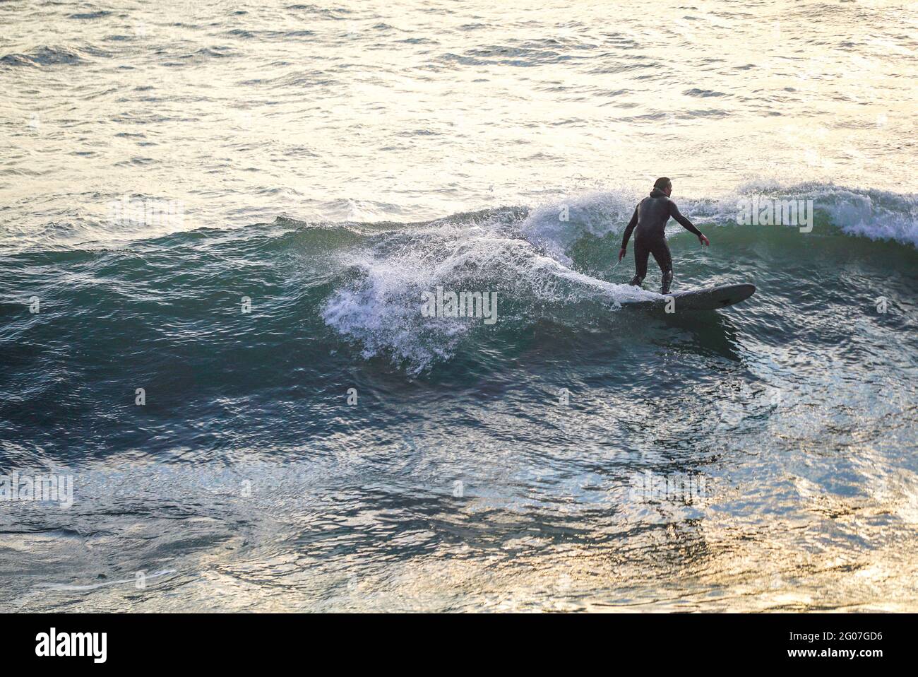Surfing at Sunset in Beach Dorset UK Stock Photo Alamy