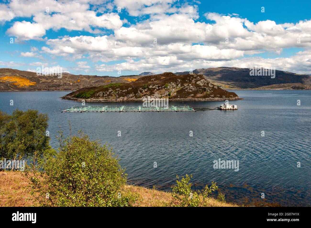 SALMON FISH REARING CAGES MOORED IN LOCH A CHAIRN BHAIN NEAR KYLESKU WEST COAST SCOTLAND Stock Photo