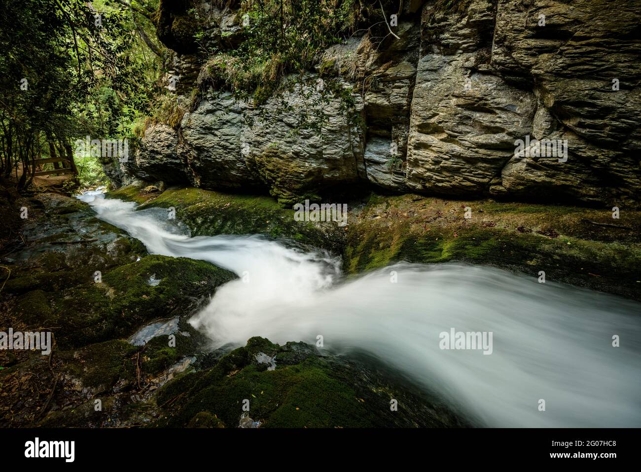 Water slide between rocks in the Bullidor de la Llet source (Berguedà, Catalonia, Spain, Pyrenees) Stock Photo