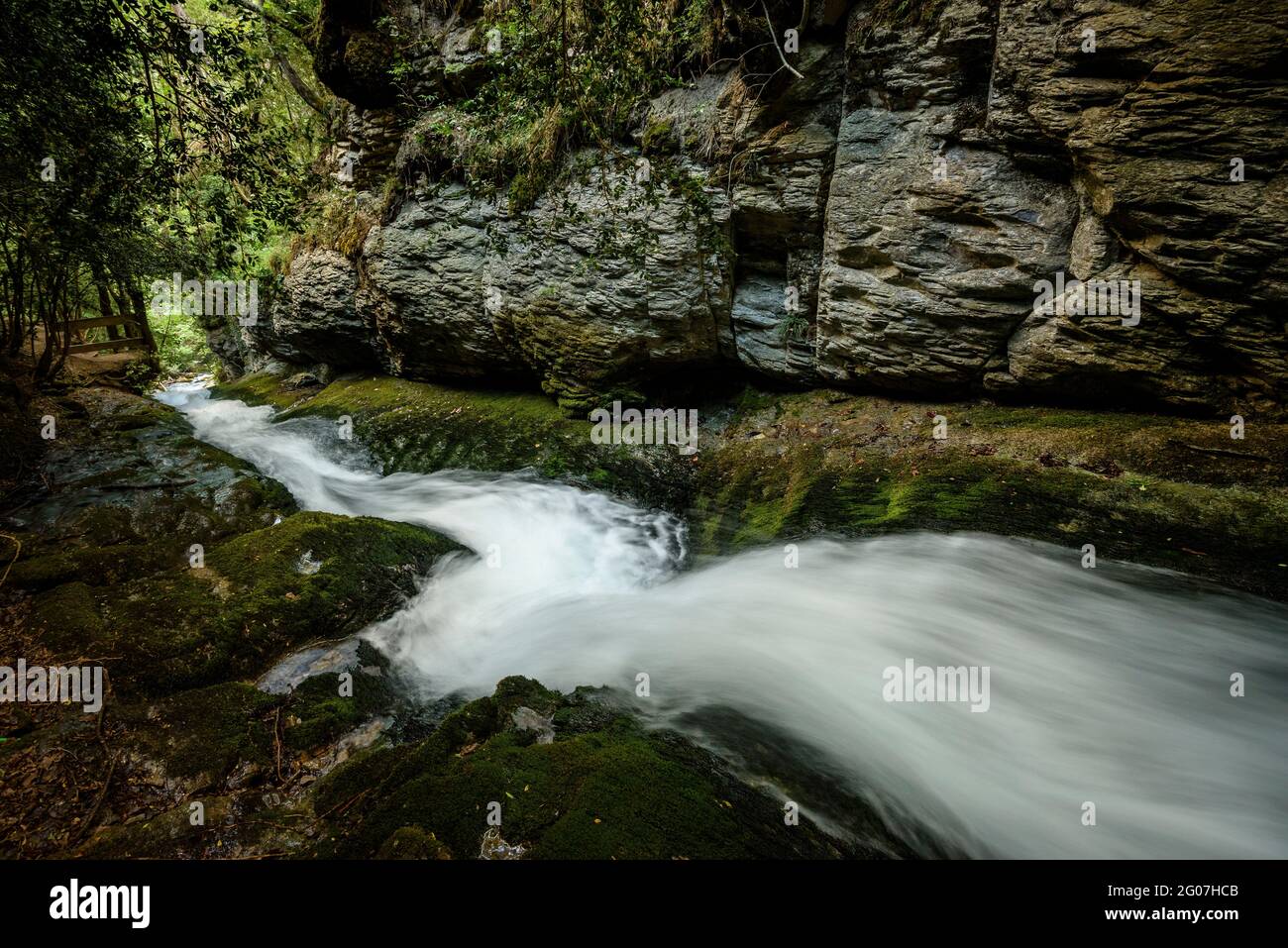 Water slide between rocks in the Bullidor de la Llet source (Berguedà, Catalonia, Spain, Pyrenees) Stock Photo
