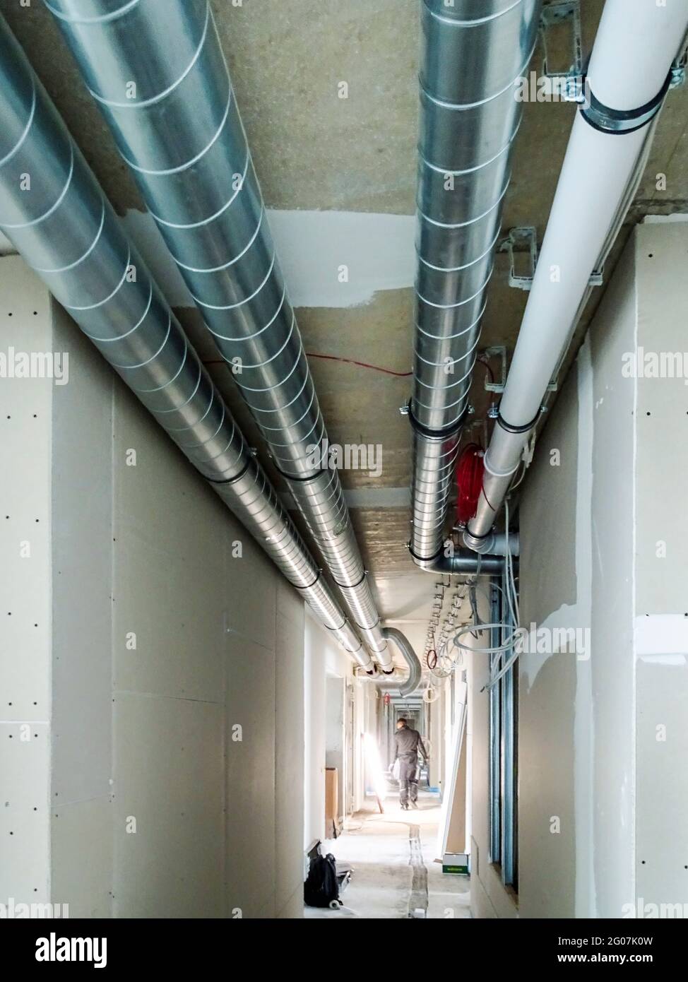 Works in progress on a building construction site with ducts and wires ...