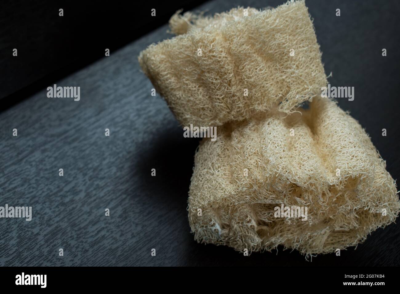 Closeup of two natural white sponge on a black wooden table Stock Photo