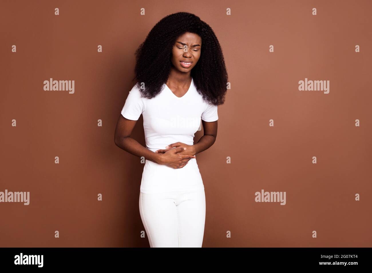 Photo Of Unsatisfied Dark Skin Person Closed Eyes Arms On Stomach Feel 