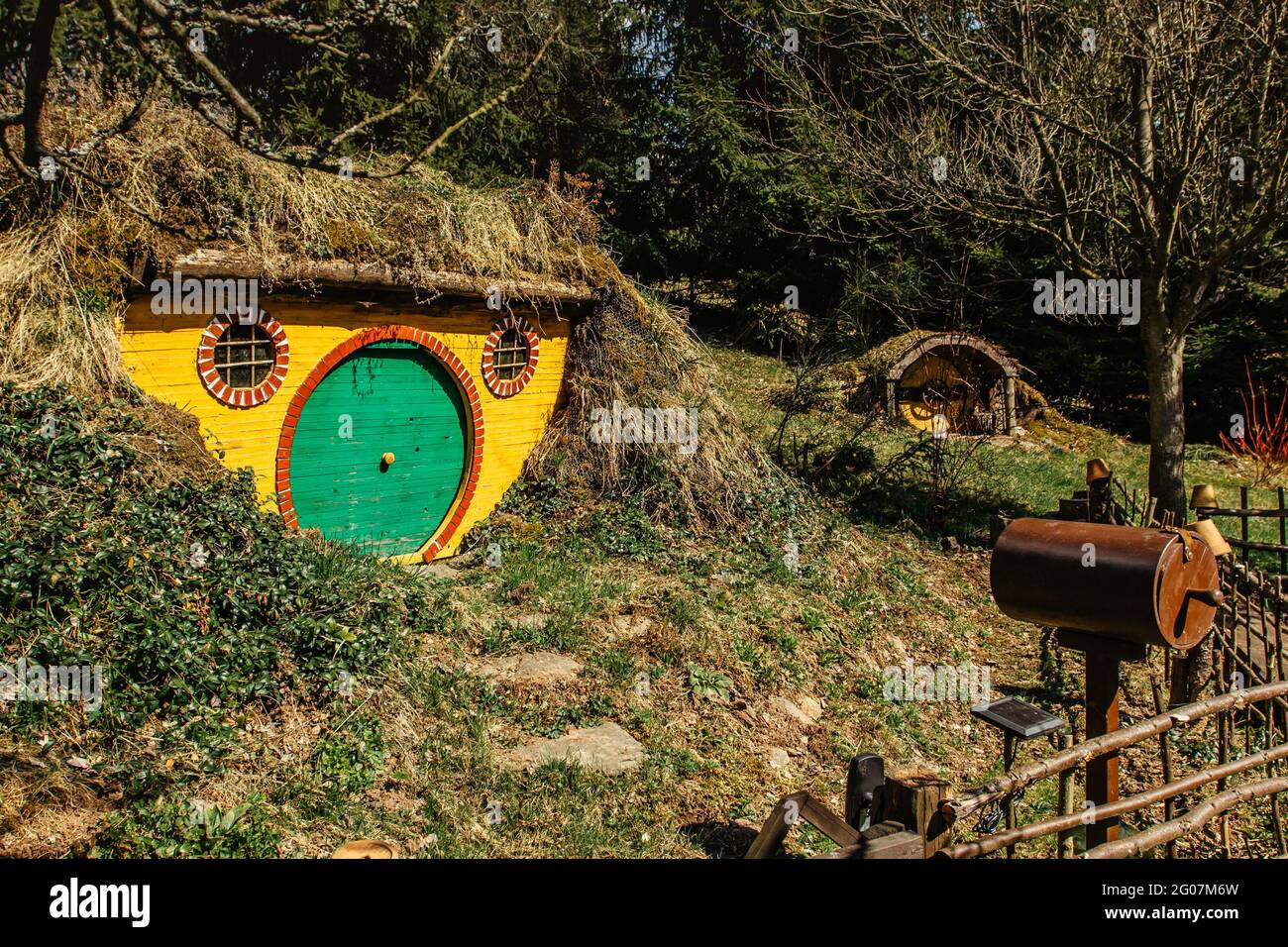 Hobbit house in Czech Hobbiton with three Hobbit holes and cute green doors.Fairy tale home in garden.Magic small village from fantasy movie located i Stock Photo