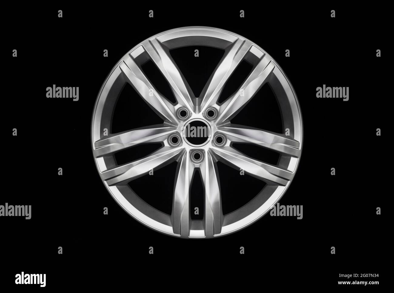 Modern aluminium wheel rim isolated on black background Stock Photo - Alamy