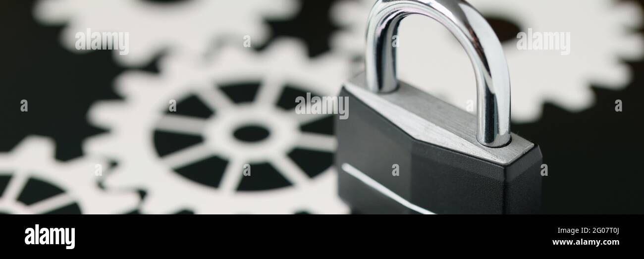Black metal padlock standing on tablet screen closeup Stock Photo