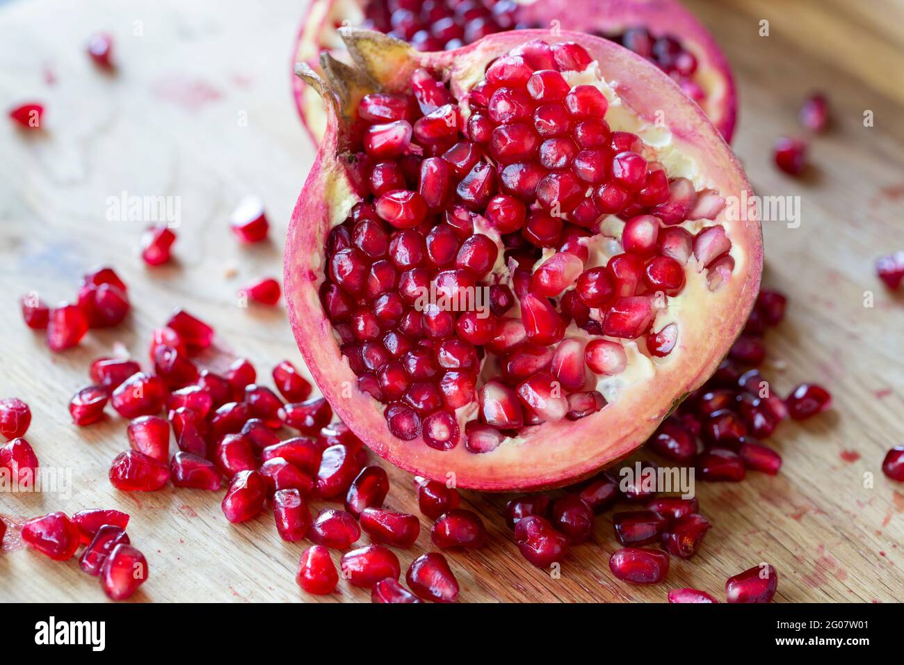 Ripe red pomegranate on wooden board and dark background Stock Photo